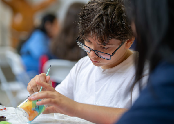 A young community member builds a fairy lantern