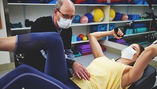NewYork-Presbyterian spine specialist helping patient with physical therapy exercises