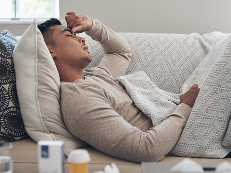 image of Man sick with new COVID-19 nimbus variant on couch