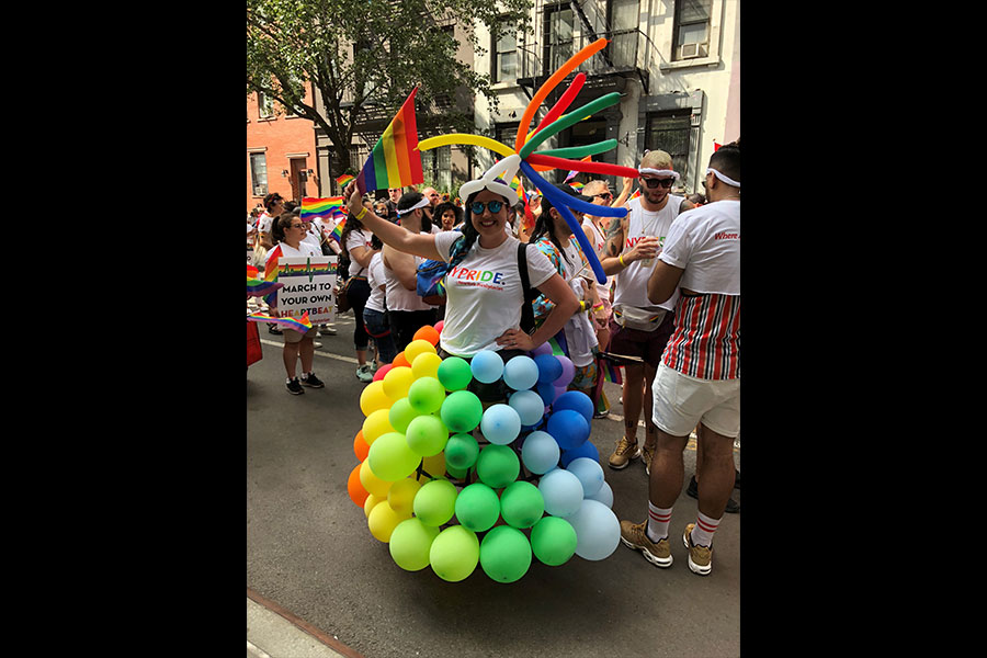 woman wearing a rainbow balloon dress