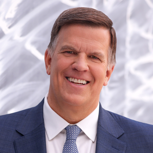 Smiling man in a suite and tie.