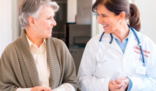 elderly woman talking to clinician