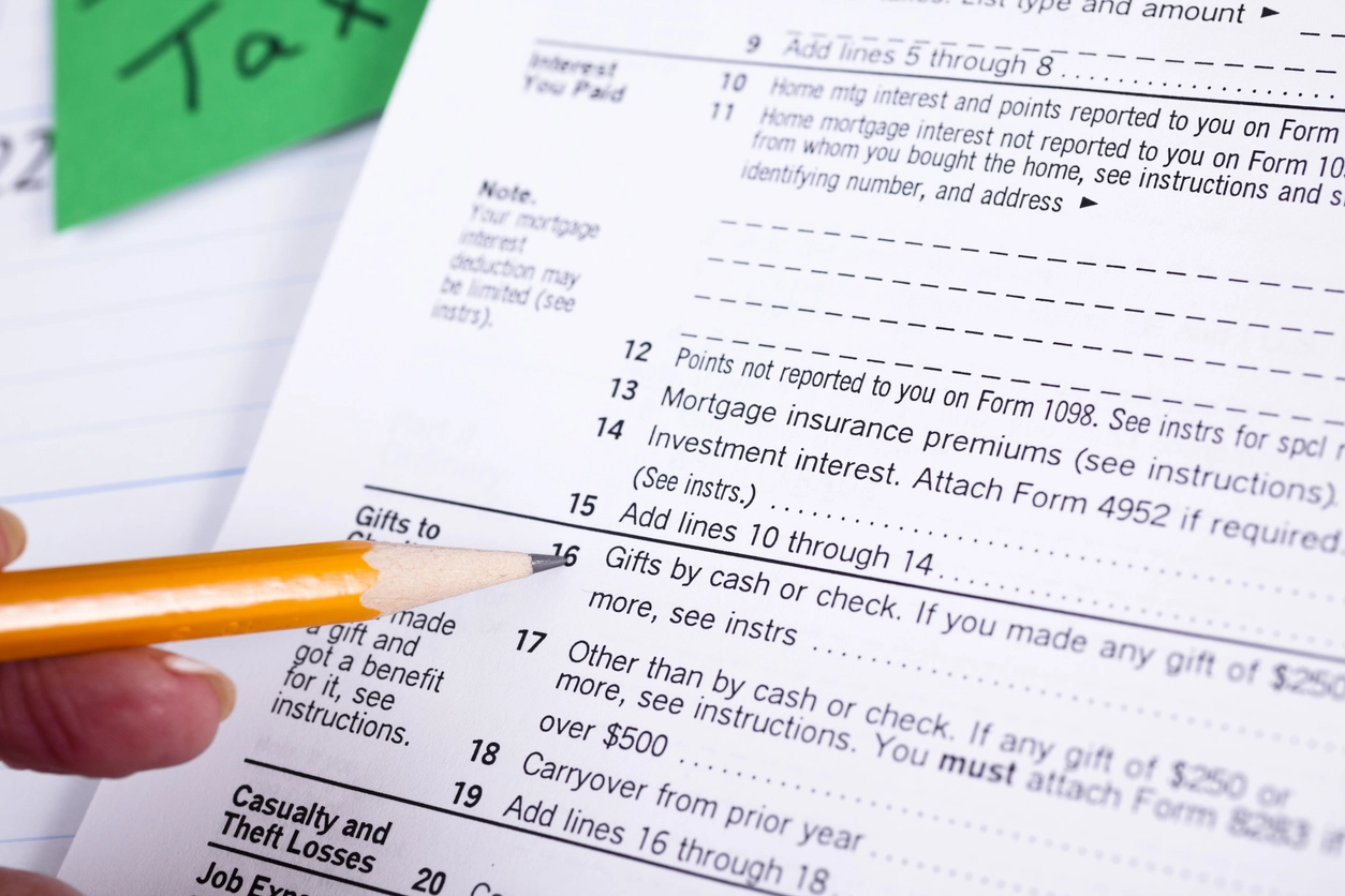 Image of  pencil pointing charitiable deductions in US tax form