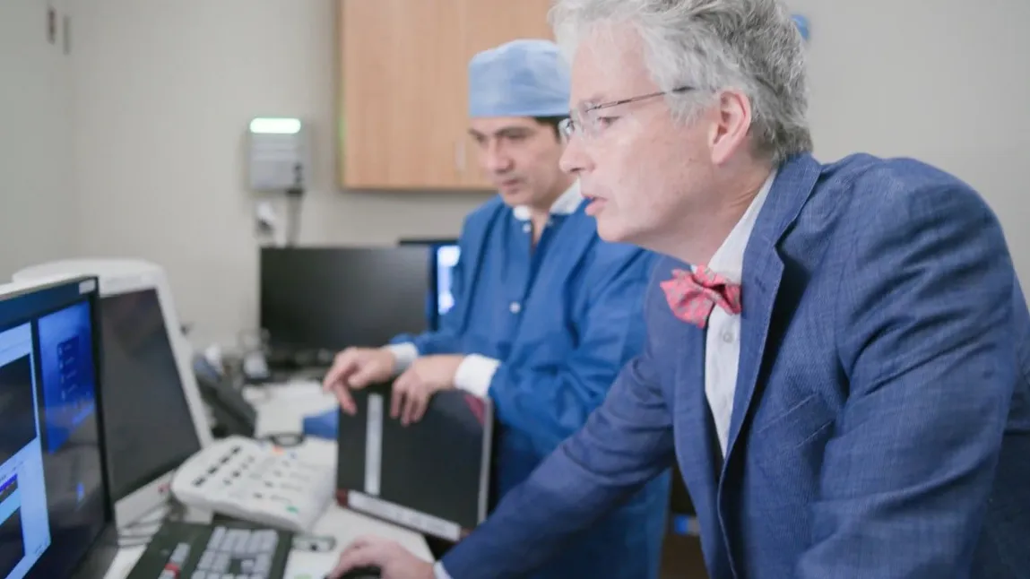 Dr. David Slotwiner and another physician looking at computer in lab.  