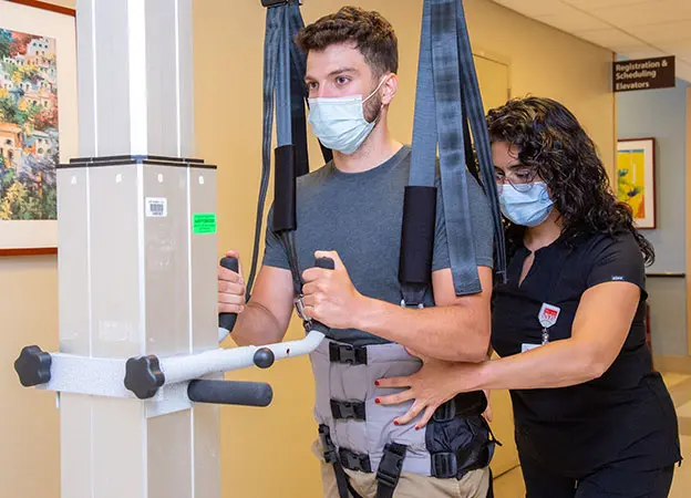 rehab guy walking with a NYP Staff